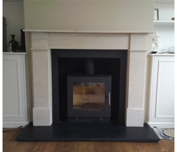 Westfire Uniq 23 Woodburner -  with flat door and block base installed with honed black granite hearths and the Flat Front Victorian limestone surround
